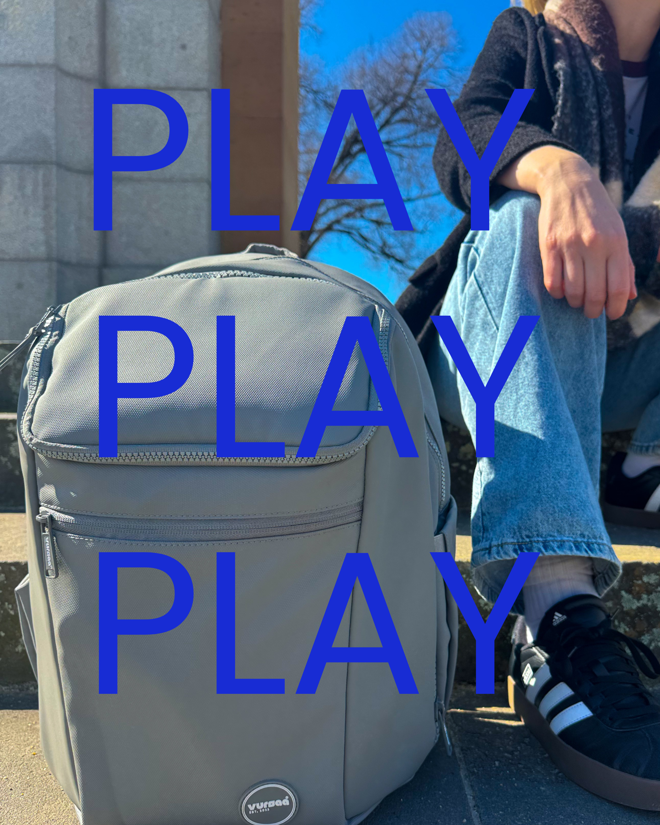 Load video: A mother packing the front PVC compartment oft eh backpack with food for the kids. Heading out for an outdoor adventure, exploring. Time to sit down for some lunch and snacks which the mum sets up and takes out the food from the backpack.