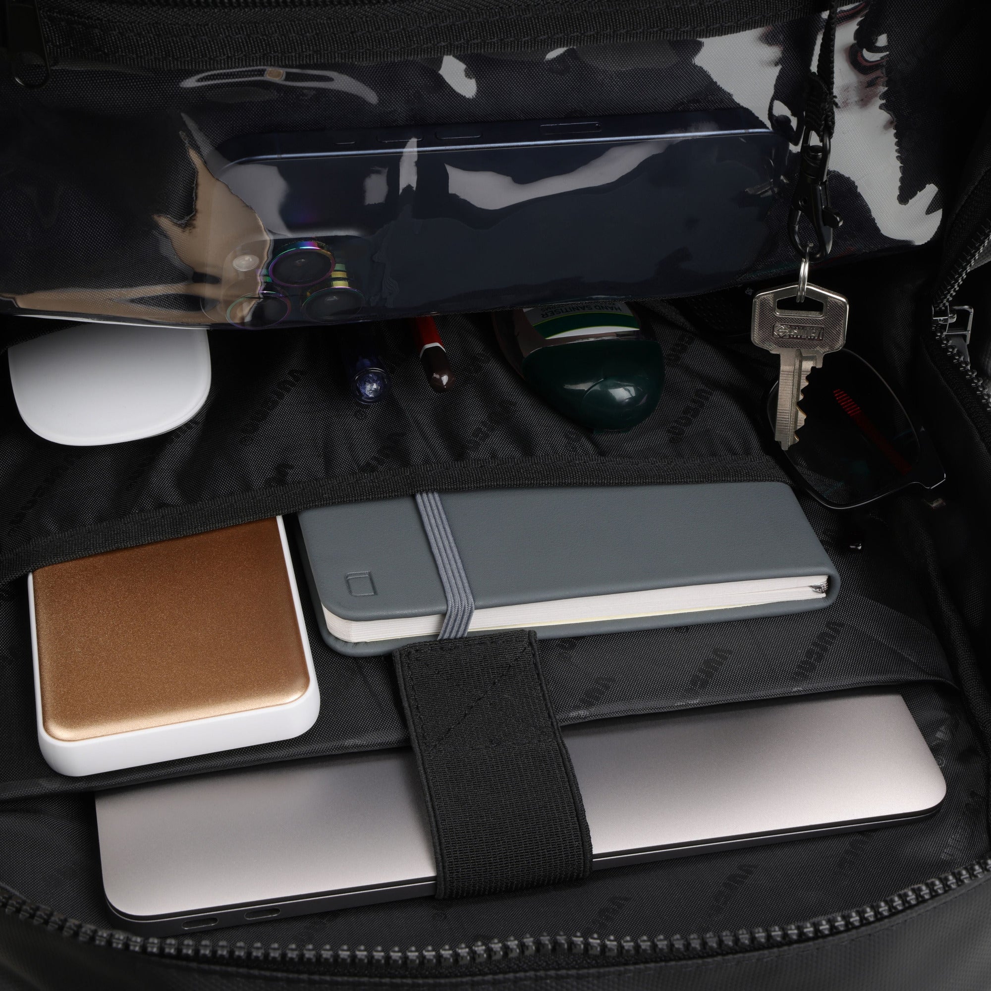 Vursaa Original Open urban black backpack with various items including a phone, notebook, and keys.