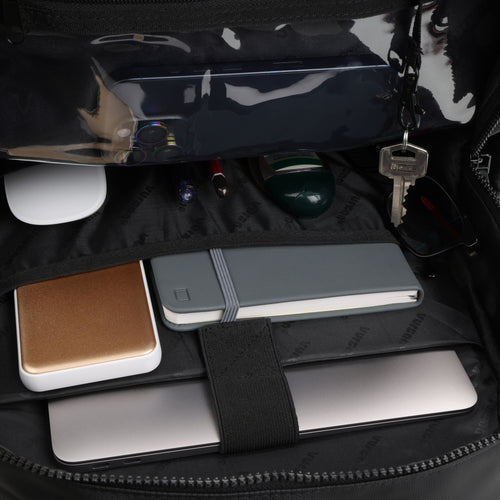 Vursaa Original Open. Urban black Vursaa backpack with various items including a phone, notebook, and keys. Internal shot of bag. 