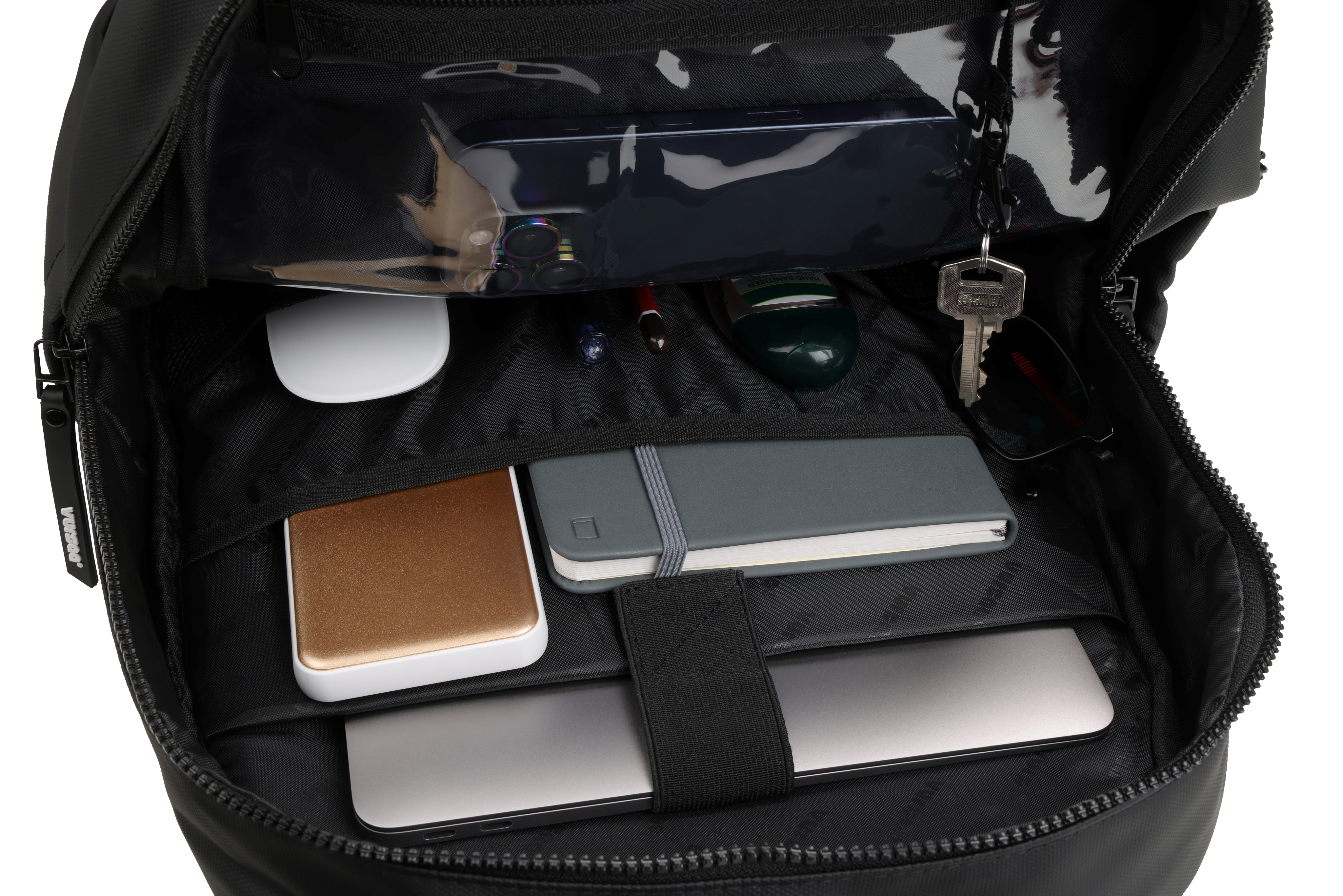Black modular backpack with organized compartments containing a laptop, mouse, and other items on a white background