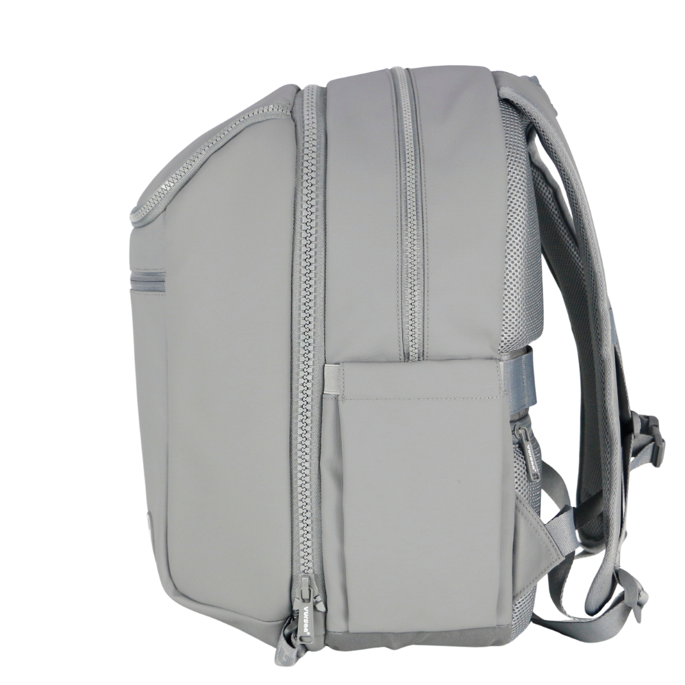 Gray modular backpack with multiple zippers on a white background. Zipper mechanism visible to detach front insulated section. 