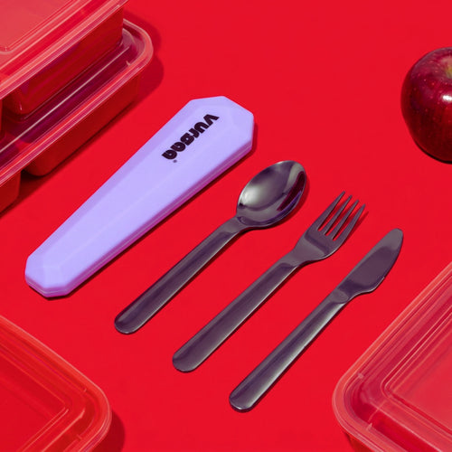 Set of steel cutlery with a purple case on a red background