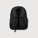 Black backpack shown from the back view, featuring padded mesh backrest, adjustable shoulder straps, and side zipper pockets, set against a light gray background.