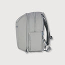 A light gray backpack shown from the side against a light gray background.