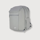 A light gray backpack with multiple zippered compartments and a small circular logo badge on the lower front, shown against a plain light gray background.