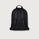 Black backpack shown from the back, featuring a textured mesh body, black zipper, and padded shoulder straps with a subtle embossed pattern, set against a light gray background.