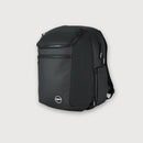A black backpack with multiple zippered compartments and a small circular logo badge on the front, shown against a light gray background.